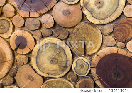 Round wooden unpainted solid natural ecological soft colored brown and yellow stumps background, Tree cut sections different sizes for pad mat background texture. Do It Yourself art concept. Round wooden unpainted solid natural ecological soft colored brown and yellow stumps background, Tree cut sections different sizes for pad mat background texture. Do It Yourself art concept. 139215024