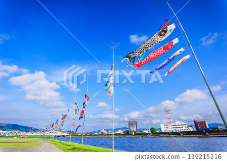 A springtime spectacle: Colorful carp streamers gracefully swimming in the Kawauchi River. A springtime spectacle: Colorful carp streamers gracefully swimming in the Kawauchi River. 139215216