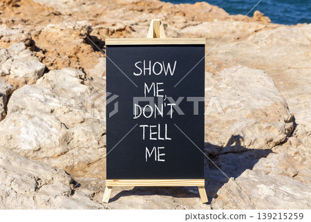 Tell or show symbol. Concept words Show me, do not tell me on beautiful black blackboard. Beautiful stone and blue sky blue sea background. Business tell or show concept. Copy space. Tell or show symbol. Concept words Show me, do not tell me on beautiful black blackboard. Beautiful stone and blue sky blue sea background. Business tell or show concept. Copy space. 139215259