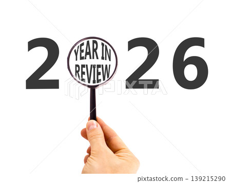 2026 year in review symbol. Concept words 2026 year in review in beautiful magnifying glass. Beautiful white background. Businessman's hand. Business 2026 year in review concept. Copy space. 139215290