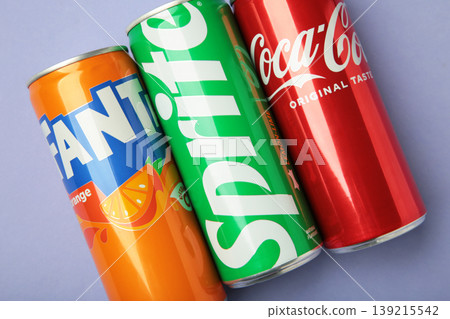 Mykolaiv, Ukraine - March 25, 2026: Iron cans of Coca Cola, Fanta and Sprite drink on purple background. Mykolaiv, Ukraine - March 25, 2026: Iron cans of Coca Cola, Fanta and Sprite drink on purple background. 139215542