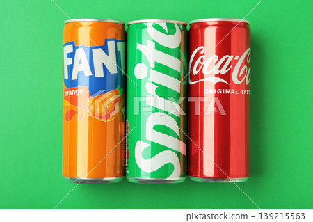 Mykolaiv, Ukraine - March 25, 2026: Iron cans of Coca Cola, Fanta and Sprite drink on green background. Mykolaiv, Ukraine - March 25, 2026: Iron cans of Coca Cola, Fanta and Sprite drink on green background. 139215563