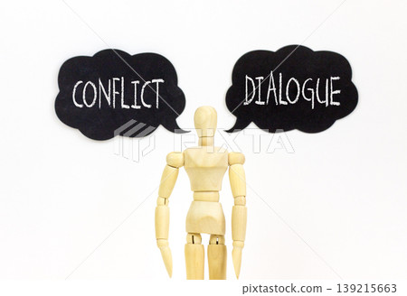 Dialogue instead conflict symbol. Concept words Dialogue and Conflict on beautiful black speech bubbles. Beautiful white background. Businessman model. Social dialogue conflict concept. Copy space. Dialogue instead conflict symbol. Concept words Dialogue and Conflict on beautiful black speech bubbles. Beautiful white background. Businessman model. Social dialogue conflict concept. Copy space. 139215663