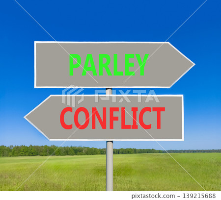 Parley instead conflict symbol. Concept words Parley and Conflict on beautiful grey road sign. Beautiful blue sky green grass background. Social and parley instead conflict concept. Copy space. Parley instead conflict symbol. Concept words Parley and Conflict on beautiful grey road sign. Beautiful blue sky green grass background. Social and parley instead conflict concept. Copy space. 139215688