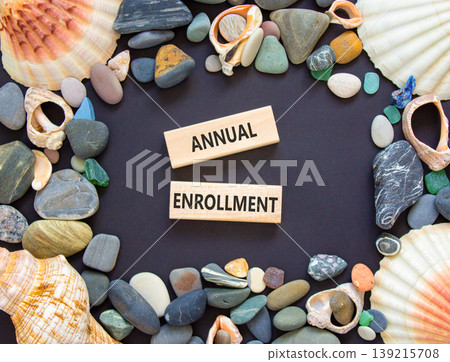 Annual enrollment words symbol. Concept words Annual enrollment on beautiful wooden blocks. Beautiful black background. Sea stones sea shells. Medical and Annual enrollment words concept. Copy space. 139215708