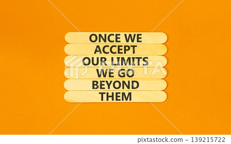 Beyond limits symbol. Concept words Once we accept our limits we go beyond them on wooden Sticks. Beautiful orange background. Business Once we accept our limits we go beyond them concept. Copy space. Beyond limits symbol. Concept words Once we accept our limits we go beyond them on wooden Sticks. Beautiful orange background. Business Once we accept our limits we go beyond them concept. Copy space. 139215722