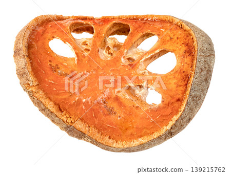 Single slice of dried bael fruit isolated. Aegle marmelos tea ingredient with orange pulp and woody rind. Traditional herbal medicine and healthy beverage concept. 139215762