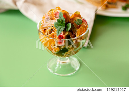 layered coffee fruit jelly dessert in glass bowl on green background 139215937