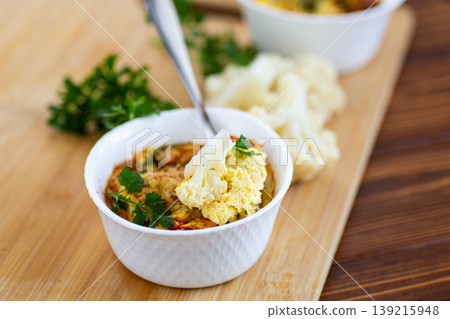 homemade egg dish with cauliflower and parsley in white ramekin homemade egg dish with cauliflower and parsley in white ramekin 139215948