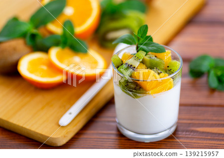 light yogurt snack with fresh kiwi orange and mint leaves light yogurt snack with fresh kiwi orange and mint leaves 139215957