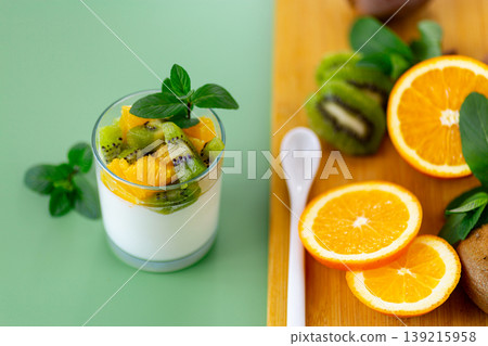 fresh yogurt with kiwi and orange slices in glass cup fresh yogurt with kiwi and orange slices in glass cup 139215958