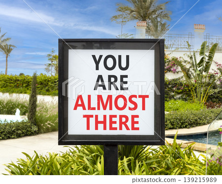You are almost there words symbol. Concept words You are almost there on beautiful white sign. Beautiful blue sky background. Business You are almost there motivational support concept. Copy space. You are almost there words symbol. Concept words You are almost there on beautiful white sign. Beautiful blue sky background. Business You are almost there motivational support concept. Copy space. 139215989