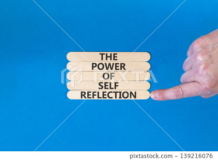 Self reflection symbol. Concept words The power of self reflection on beautiful wooden sticks. Beautiful blue background. Businessman hand. Business the power of self reflection concept. Copy space. 139216076
