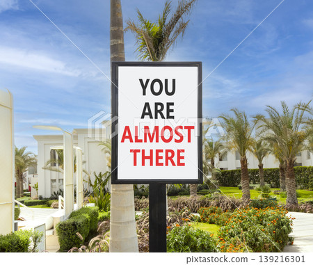 You are almost there words symbol. Concept words You are almost there on beautiful white sign. Beautiful blue sky background. Business You are almost there motivational support concept. Copy space. You are almost there words symbol. Concept words You are almost there on beautiful white sign. Beautiful blue sky background. Business You are almost there motivational support concept. Copy space. 139216301