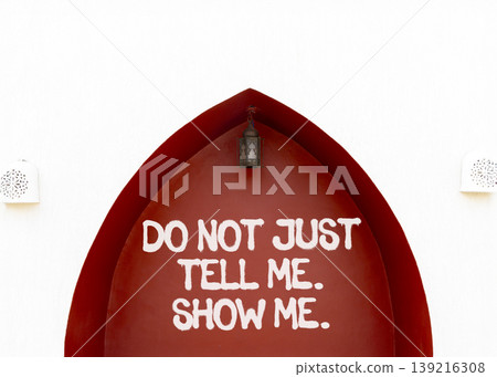 Tell or show symbol. Concept words Do not just tell me, show me on beautiful red wall. Beautiful white wall background. Business tell or show concept. Copy space. Tell or show symbol. Concept words Do not just tell me, show me on beautiful red wall. Beautiful white wall background. Business tell or show concept. Copy space. 139216308