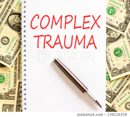 Complex trauma words symbol. Concept words Complex trauma on beautiful white note. Beautiful dollar bills background. Dollar bills. Psychological complex trauma support concept. Copy space. Complex trauma words symbol. Concept words Complex trauma on beautiful white note. Beautiful dollar bills background. Dollar bills. Psychological complex trauma support concept. Copy space. 139216339