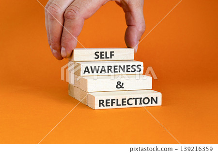 Self awareness and reflection symbol. Concept words Self awareness and reflection on beautiful wooden blocks. Beautiful orange background. Psychological self awareness reflection concept. Copy space. Self awareness and reflection symbol. Concept words Self awareness and reflection on beautiful wooden blocks. Beautiful orange background. Psychological self awareness reflection concept. Copy space. 139216359