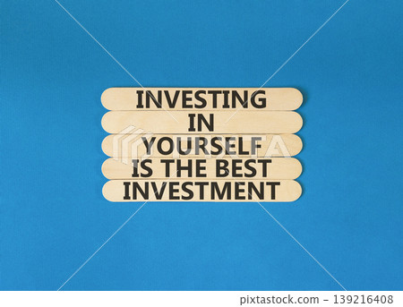 Investing in yourself symbol. Concept words Investing in yourself is the best investment on beautiful wooden sticks. Beautiful blue background. Business investing in yourself concept. Copy space Investing in yourself symbol. Concept words Investing in yourself is the best investment on beautiful wooden sticks. Beautiful blue background. Business investing in yourself concept. Copy space 139216408