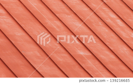 Metal roof painted in red. Warm, rustic texture with diagonal lines 139216685