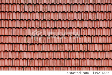 Front view of red terracotta tiles laid in tight, overlapping rows 139216686