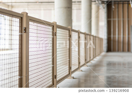Temporary safety fence line in an unfinished building with concrete columns and walls Temporary safety fence line in an unfinished building with concrete columns and walls 139216908