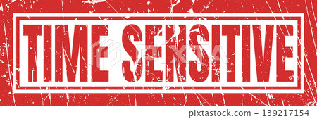 Time sensitive red grunge stamp with white border and heavily weathered textured appearance. 139217154