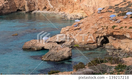 Resort view of rocky coast with parasols Resort view of rocky coast with parasols 139217218