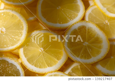 Sliced lemons arranged in vibrant patterns create a refreshing burst of color 139217407
