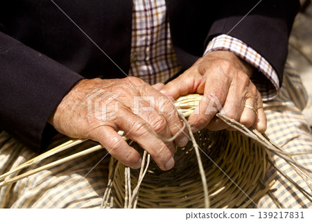 basketry craftsman hands working in Mediterranean basket 139217831