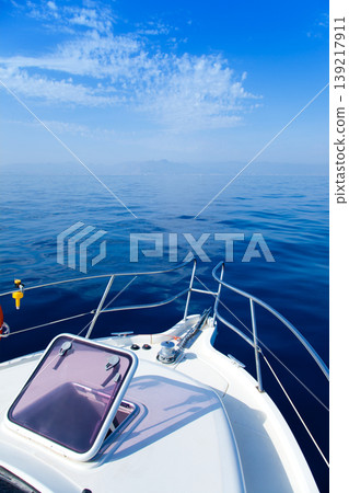 Blue sea boat sailing with open bow porthole 139217911