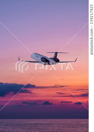 Executive aircraft take off over the ocean against the backdrop of scenic sunset sky 139217925