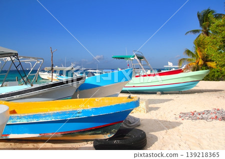 colorful tropical boats beached in sand Isla Mujeres colorful tropical boats beached in sand Isla Mujeres 139218365