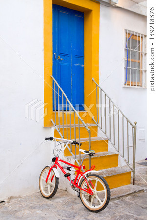 Ibiza white facade in blue door stairs Ibiza white facade in blue door stairs 139218376