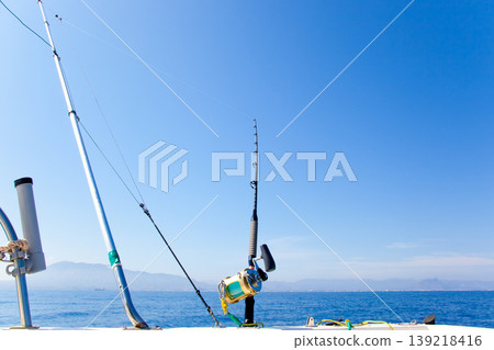 fishing boat trolling with outrigger gear 139218416