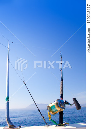 fishing boat trolling with outrigger gear fishing boat trolling with outrigger gear 139218417