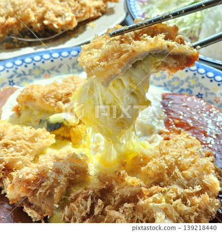 delicious crispy golden fried pork cutlet with melted mozzarella cheese delicious crispy golden fried pork cutlet with melted mozzarella cheese 139218440