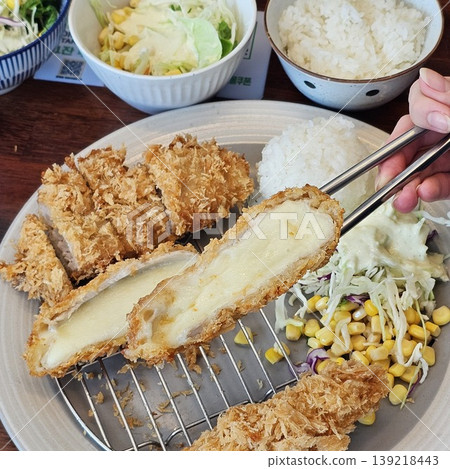 delicious crispy golden fried pork cutlet with melted mozzarella cheese delicious crispy golden fried pork cutlet with melted mozzarella cheese 139218443