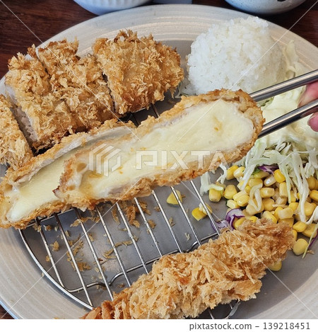 delicious crispy golden fried pork cutlet with melted mozzarella cheese delicious crispy golden fried pork cutlet with melted mozzarella cheese 139218451
