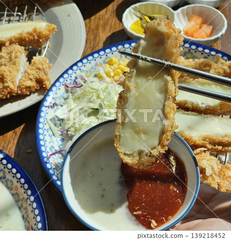 delicious crispy golden fried pork cutlet with melted mozzarella cheese delicious crispy golden fried pork cutlet with melted mozzarella cheese 139218452