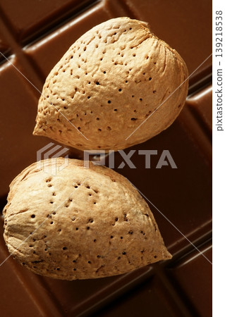 Almond nuts over chocolate, delicious golden food Almond nuts over chocolate, delicious golden food 139218538
