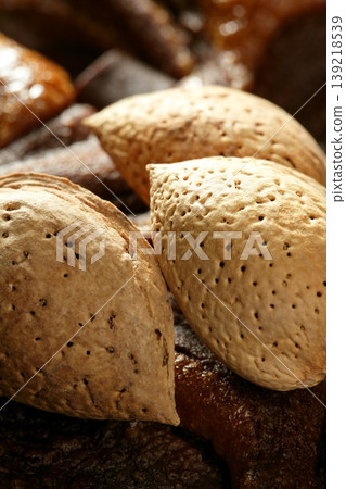 Almond nuts over chocolate, delicious golden food Almond nuts over chocolate, delicious golden food 139218539