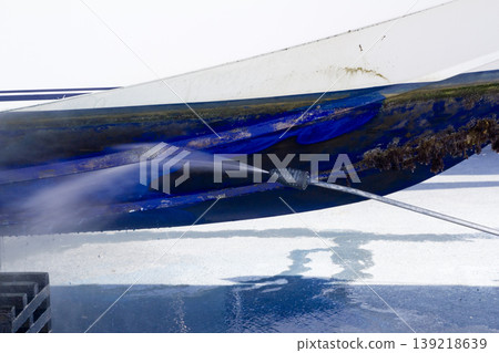 blue boat hull cleaning pressure washer barnacles blue boat hull cleaning pressure washer barnacles 139218639