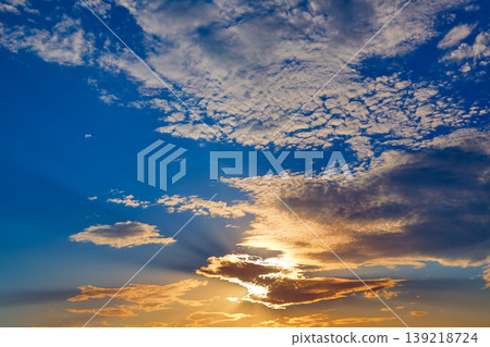 Sunset sky with golden and blue clouds Sunset sky with golden and blue clouds 139218724