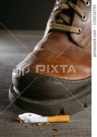 broken cigarette tread by a boot 139218785