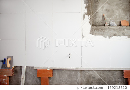 tiles white wall contruction with trowels tools tiles white wall contruction with trowels tools 139218810