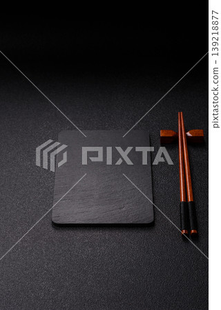 Empty slate board with wooden chopsticks for Asian food. Empty slate board Empty slate board with wooden chopsticks for Asian food. Empty slate board 139218877