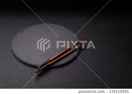 Empty slate board with wooden chopsticks for Asian food. Empty slate board Empty slate board with wooden chopsticks for Asian food. Empty slate board 139218895