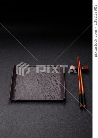 Empty slate board with wooden chopsticks for Asian food. Empty slate board 139218905