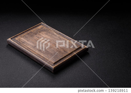 An empty wooden cutting board, kitchen utensils for food preparation. An empty cutting board An empty wooden cutting board, kitchen utensils for food preparation. An empty cutting board 139218911