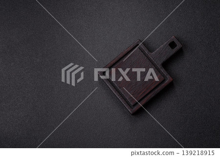 An empty wooden cutting board, kitchen utensils for food preparation. An empty cutting board An empty wooden cutting board, kitchen utensils for food preparation. An empty cutting board 139218915
